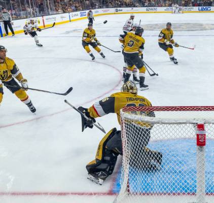 Golden Knights goaltender Logan Thompson (36) deflects a shot away from the net by the Chicago ...