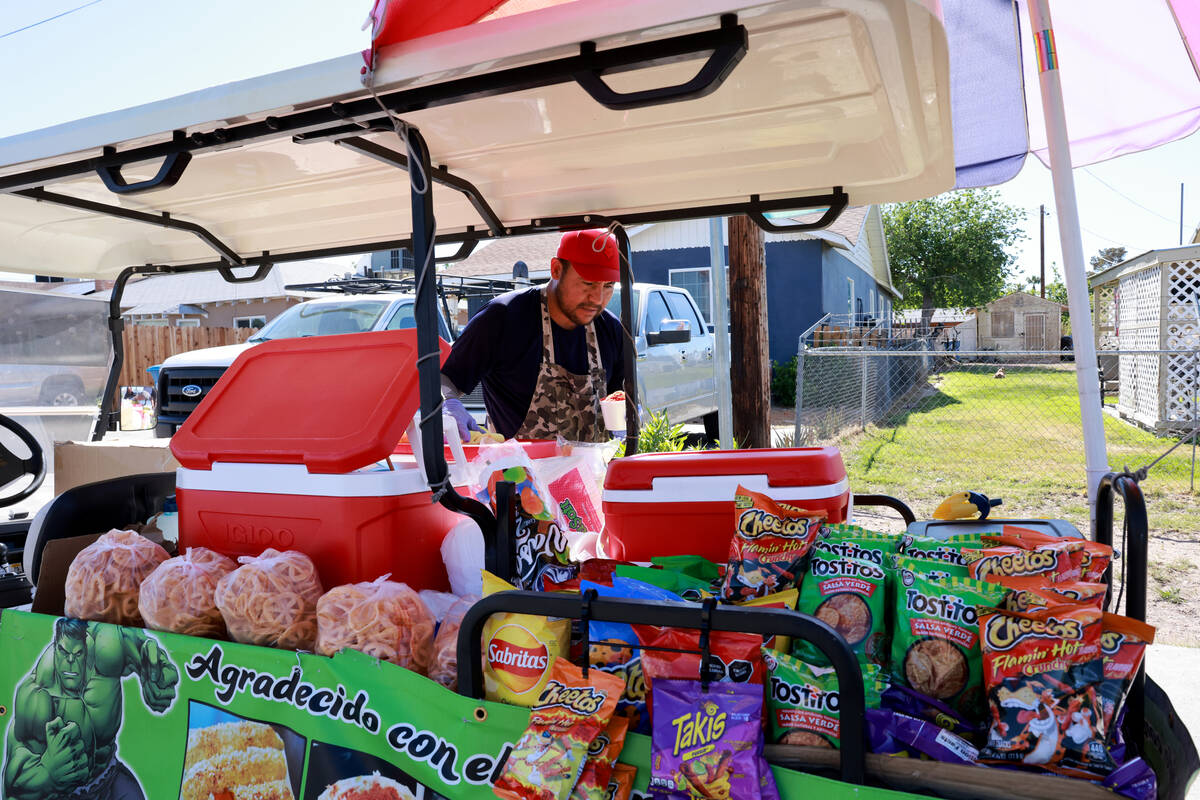 Sidewalk vendor Oracio Gonzalez Moreno makes a customer’s order in Las Vegas Tuesday, Ap ...