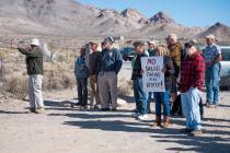 Karl Olson points toward a proposed solar farm location, with Rhyolite ghost town in the backgr ...