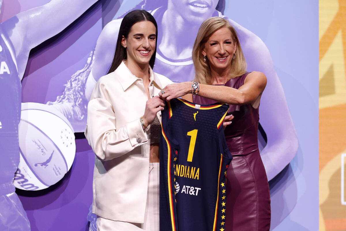 Caitlin Clark poses with WNBA Commissioner Cathy Engelbert after being selected as the first ov ...