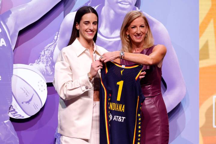 Caitlin Clark poses with WNBA Commissioner Cathy Engelbert after being selected as the first ov ...