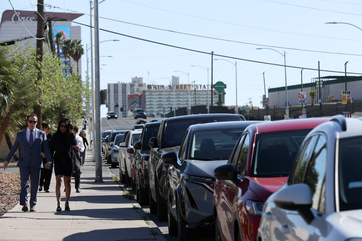 Cars line the street after the parking lot filled while attendees head to Dennis Prince’s fun ...