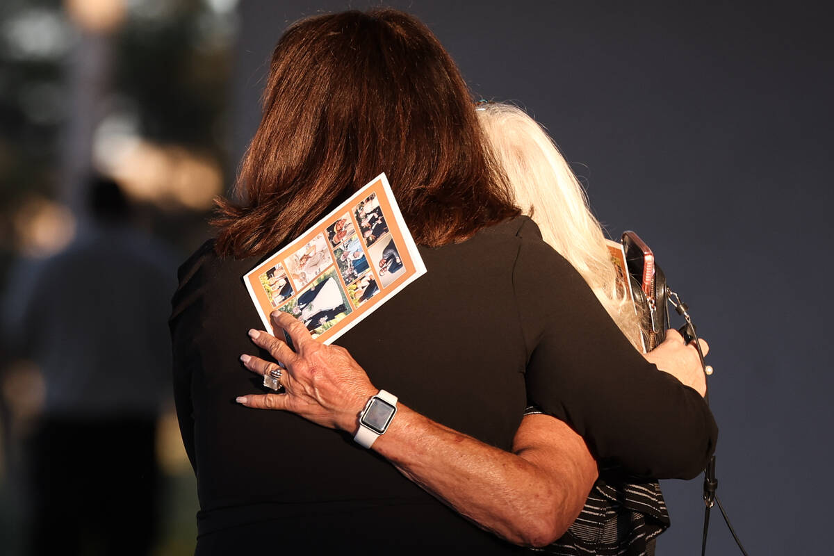 Loved ones of Dennis Prince, 57, embrace after the Las Vegas attorney’s funeral outside Palm ...