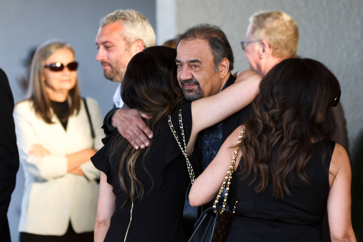 Loved ones of Dennis Prince, 57, embrace after the Las Vegas attorney’s funeral outside Palm ...