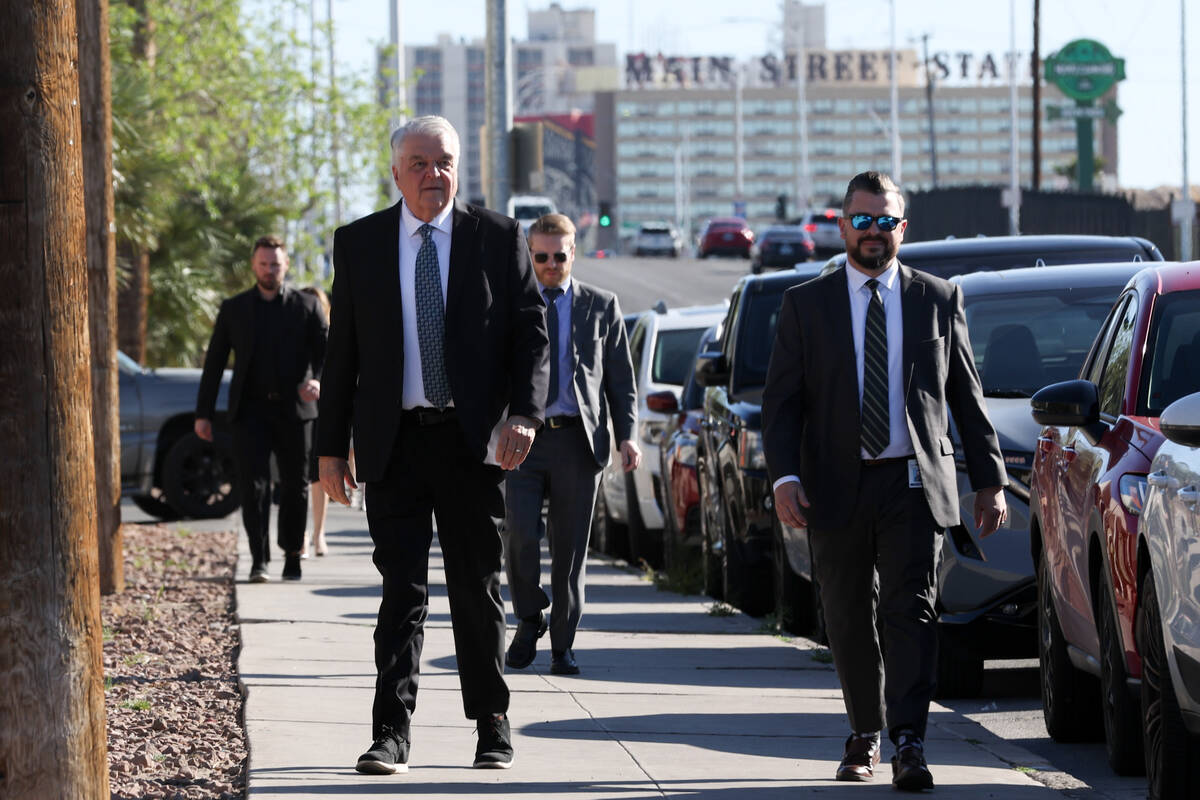 Former Gov. Steve Sisolak, left, enters the funeral of Las Vegas attorney Dennis Prince at Palm ...