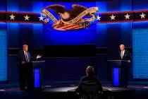 Moderator Chris Wallace of Fox News listens as Donald Trump and Joe Biden participate in the a ...