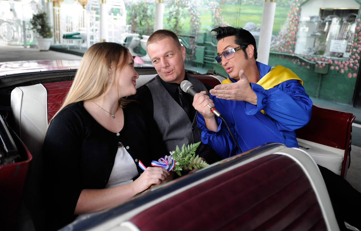 Emily and Sheldon Smith sing along with Elvis impersonator Jesse Garon during their wedding ren ...