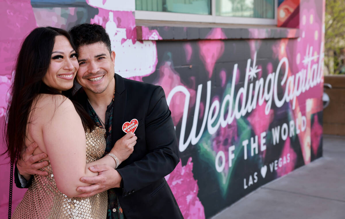 Jackie Cardenas-Bonal and Roberto Bonal of Las Vegas pose with “Married in Vegas” ...