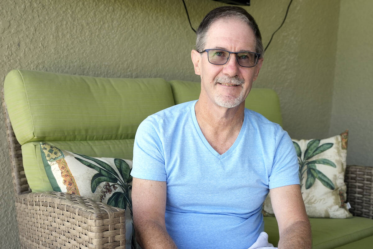 Scott Berkheiser, 57, who has Alzheimer's disease, sits for a portrait at his home Friday, Apri ...