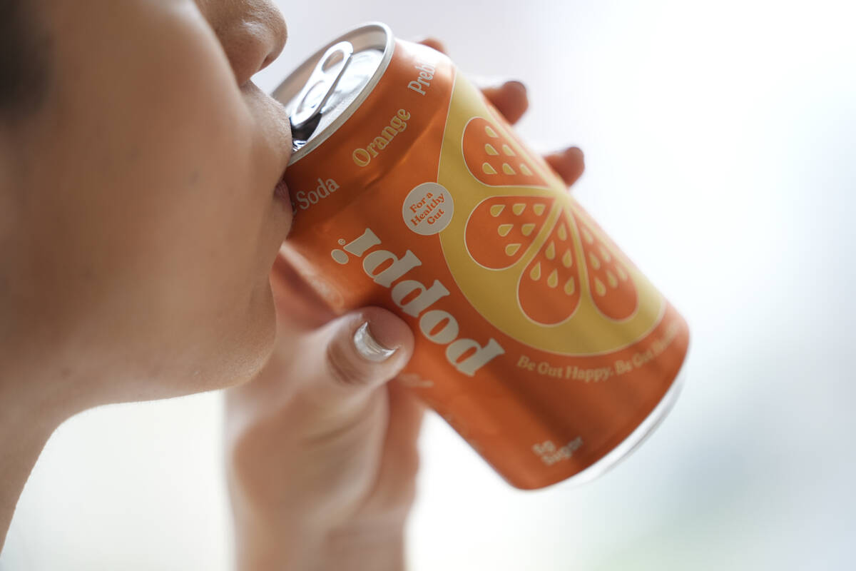 A person drinks Poppi, a prebiotic soda, on Wednesday, April 10, 2024, in New York. A fitness i ...