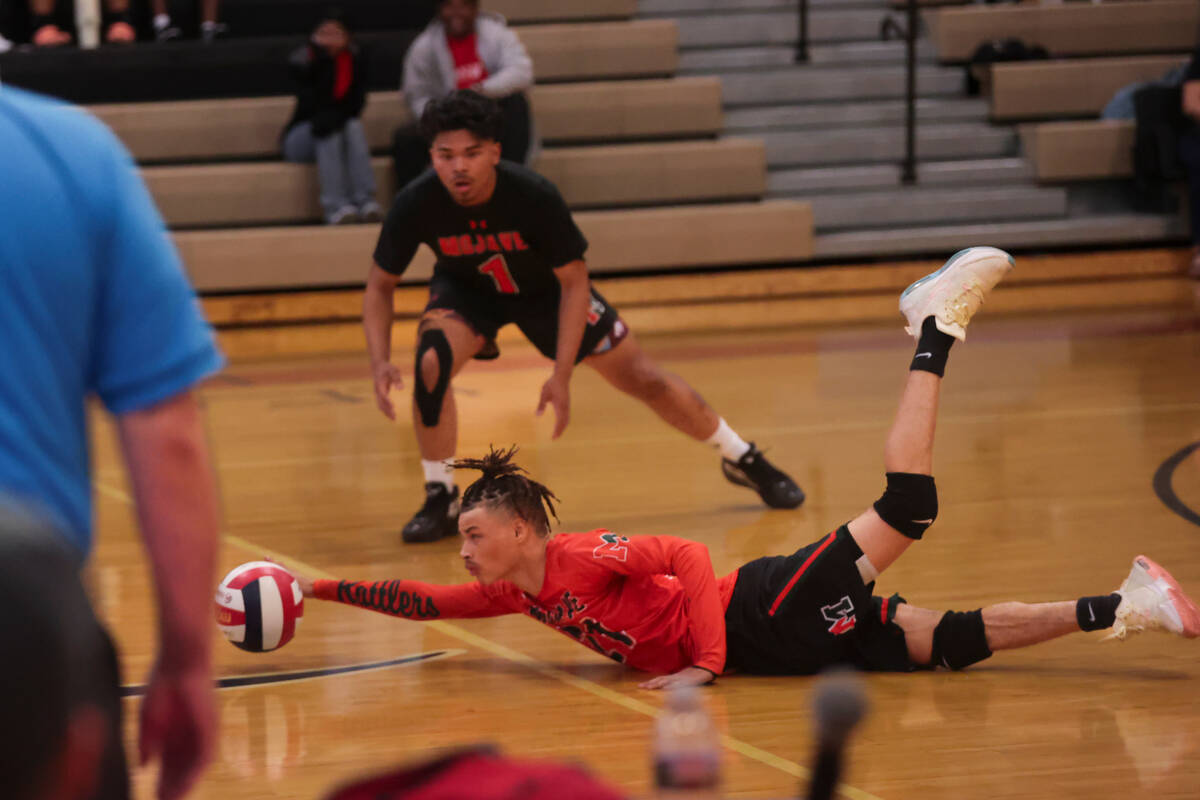 Mojave libero Creighton Thomas (21) attempts a diving save on a shot from Legacy during a boys ...