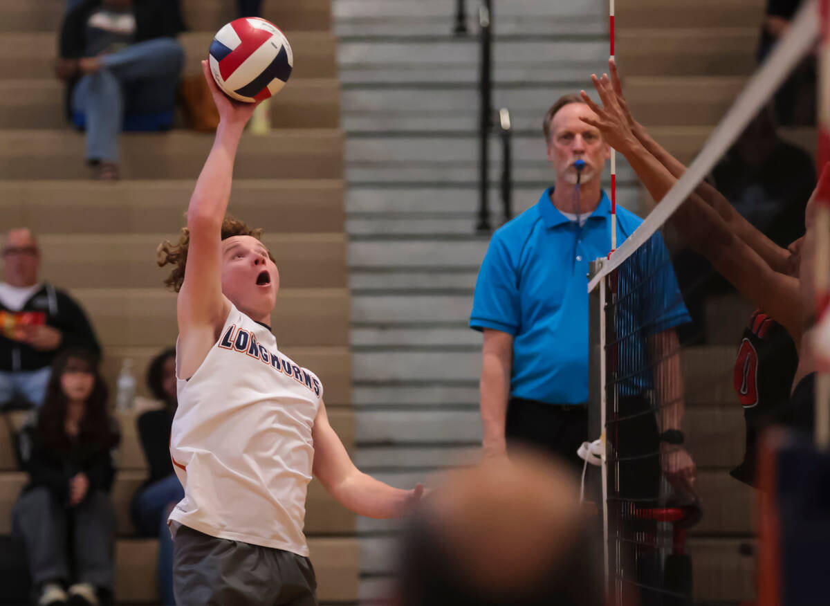 Legacy's Logan Hanshew (10) sends the ball over to Mojave during a boys high school volleyball ...