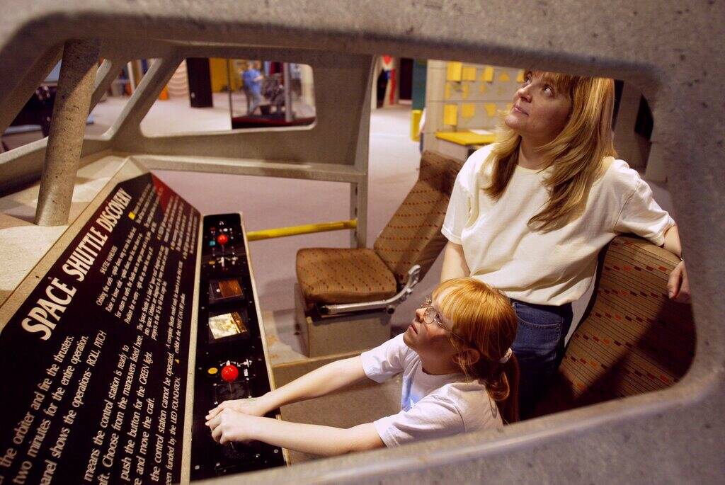 Lori Austin and her daughter Amanda, 7, experience the Space Shuttle exhibit at the Lied Discov ...