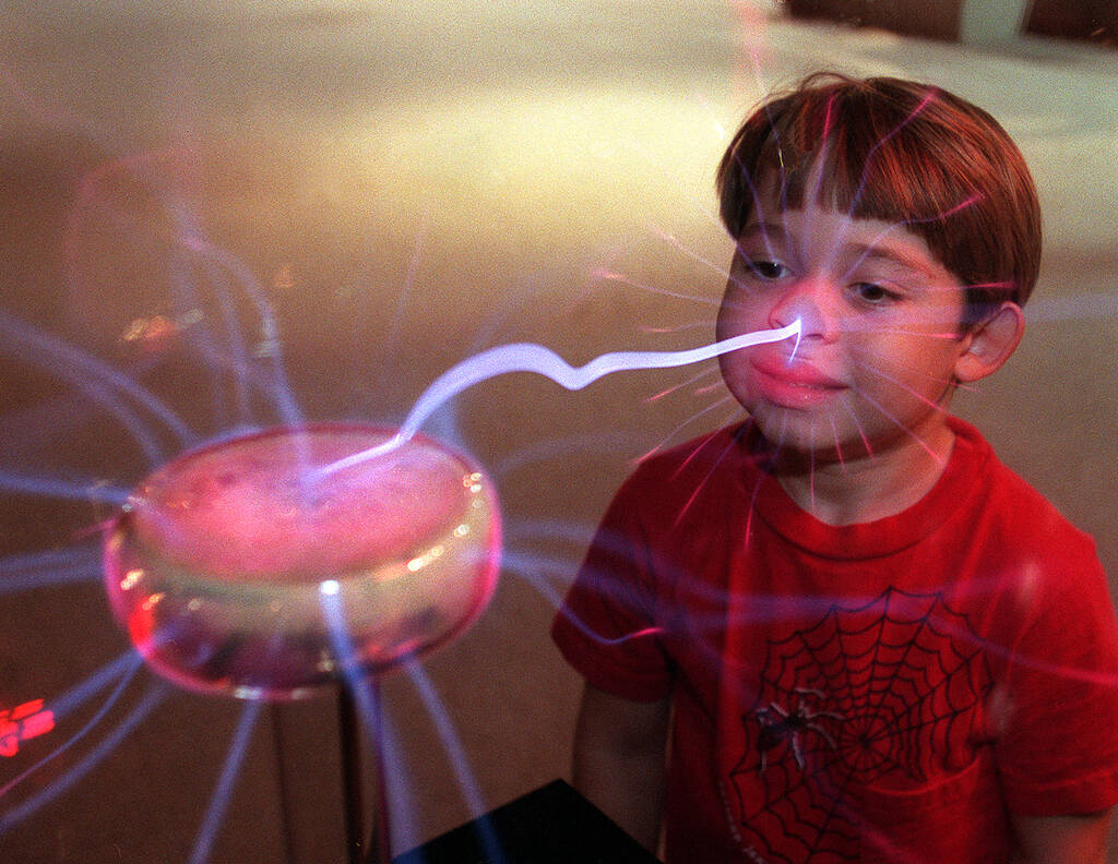 Mitchell Stomner, 6 years old, takes a bolt on the nose as he checks out the plazma ball exhibi ...