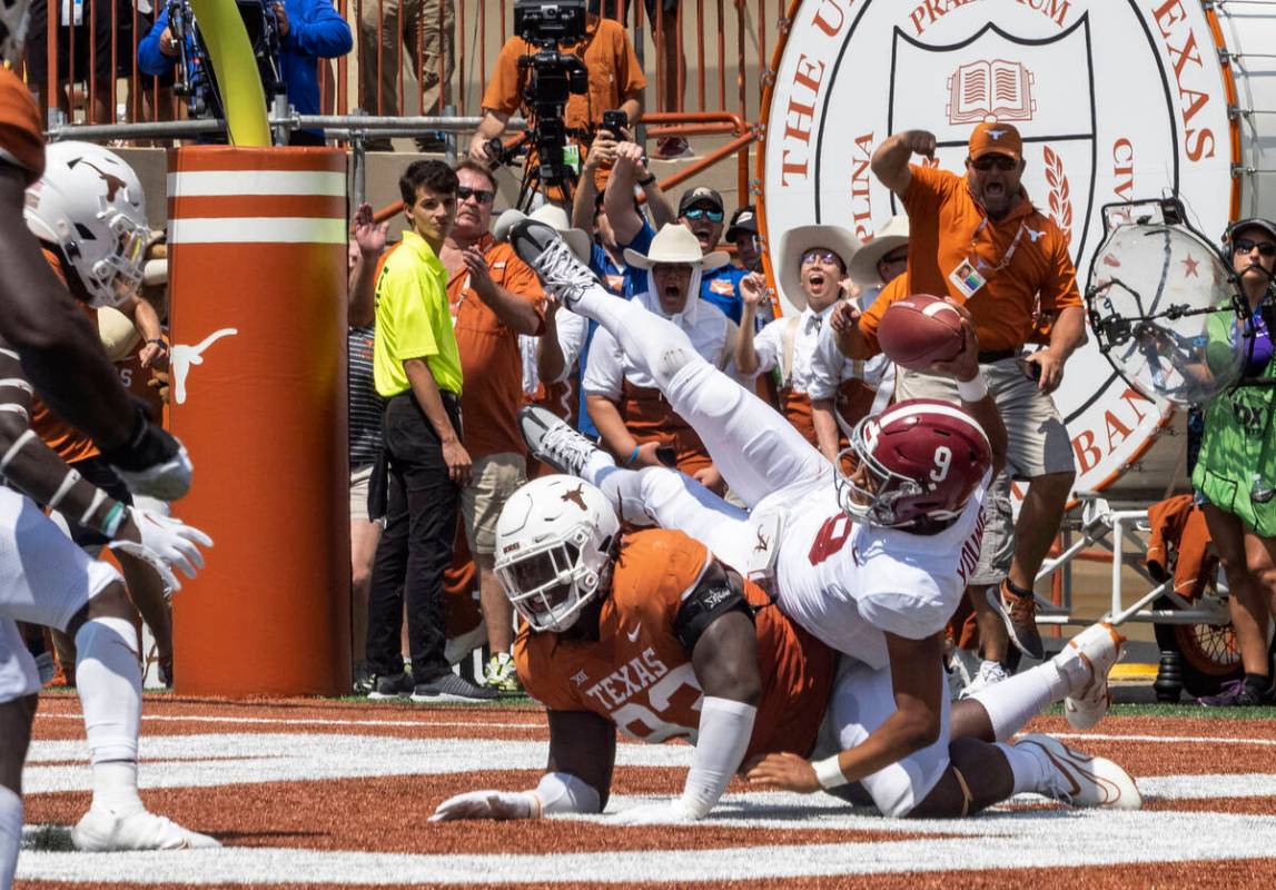 Texas defensive edge rusher T'Vondre Sweat knocks down Alabama quarterback Bryce Young (9) in t ...