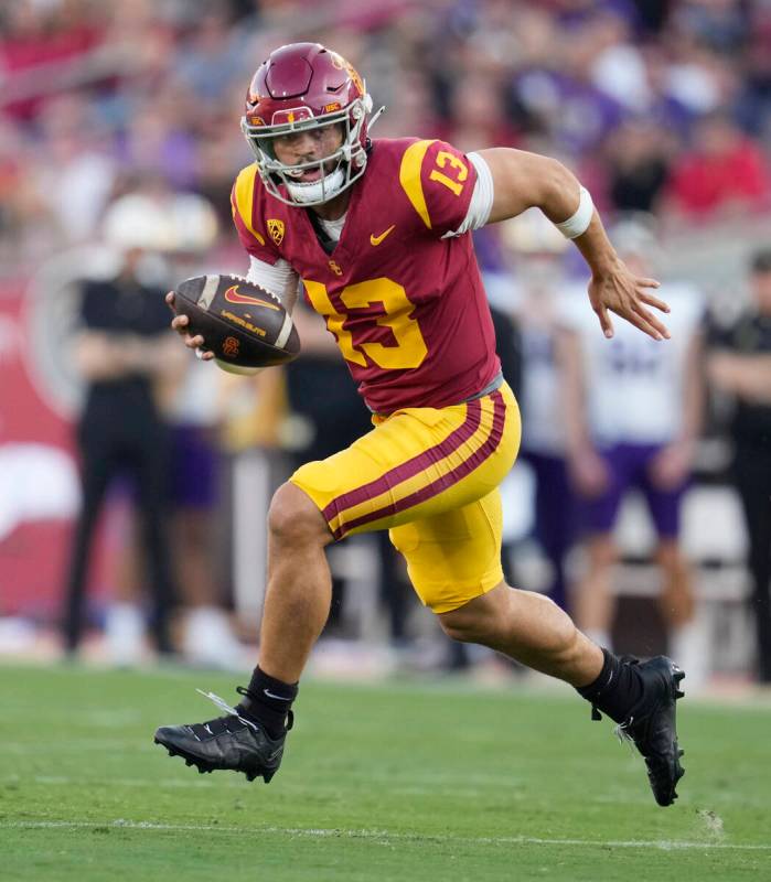 FILE - Southern California quarterback Caleb Williams (13) runs during the first half of an NCA ...