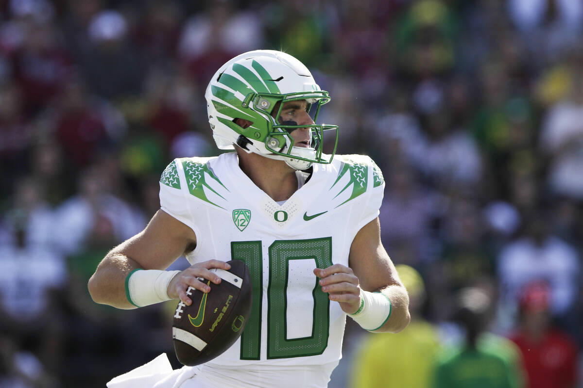 Oregon quarterback Bo Nix looks for a receiver during the first half of an NCAA college footbal ...