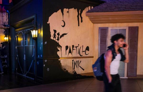 A person walks past the door for Particle Ink, a new immersive attraction/performance show open ...