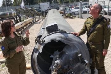 Israeli military spokesman Rear Admiral Daniel Hagari, right, and his deputy Masha Michelson po ...