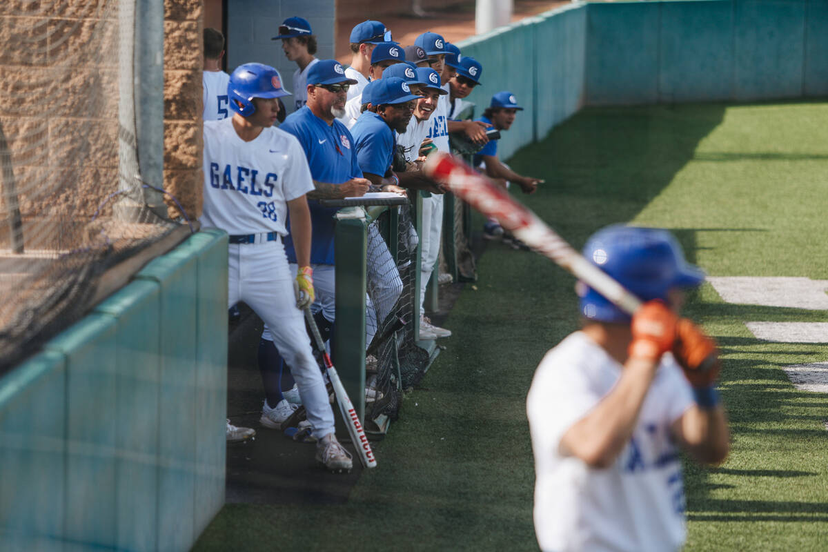 Bishop Gorman players hang out of the dug out during an baseball game between Bishop Gorman and ...