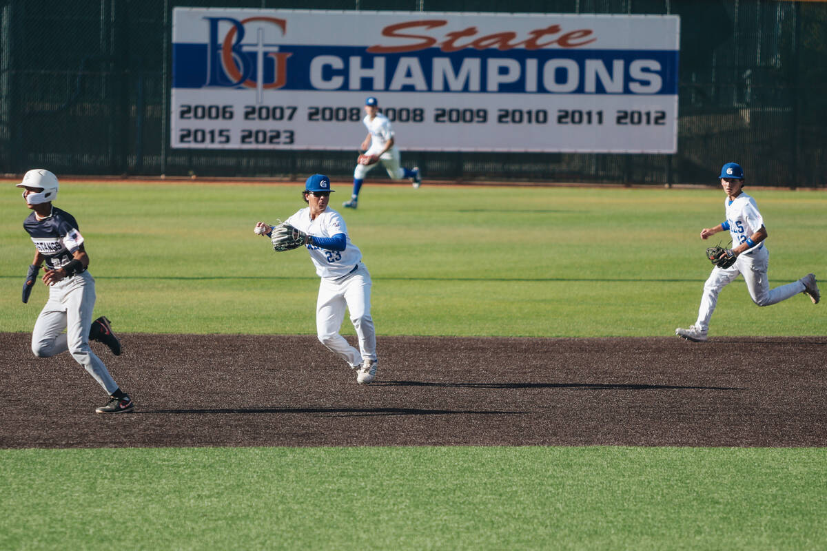 Bishop Gorman third baseman Noah Ramos (23) throws the ball to a teammate to help with an out d ...