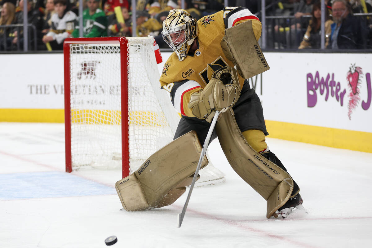 Golden Knights goaltender Logan Thompson (36) tips the puck toward a teammate during the second ...