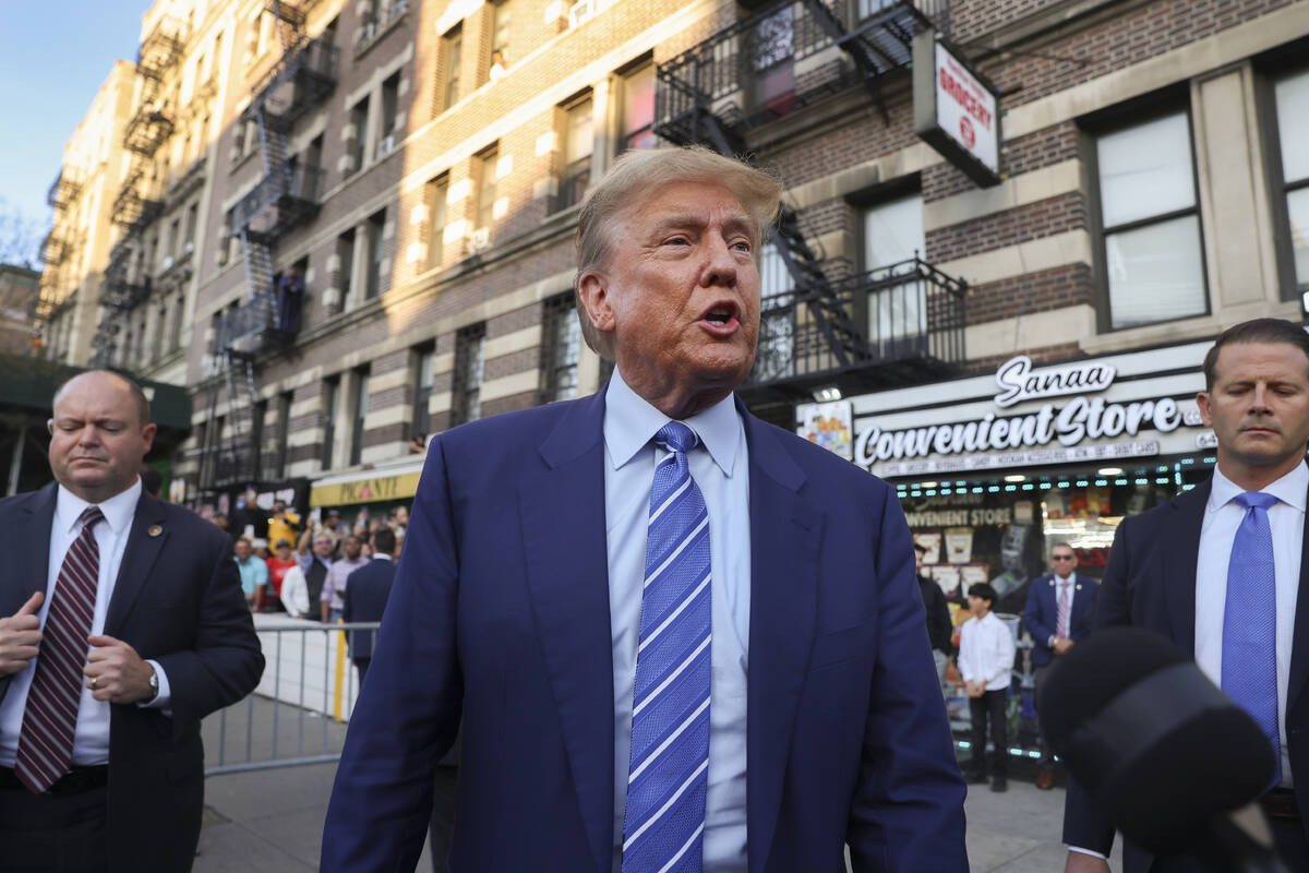 Former president Donald Trump, talks to members of the media while visiting a bodega, Tuesday, ...