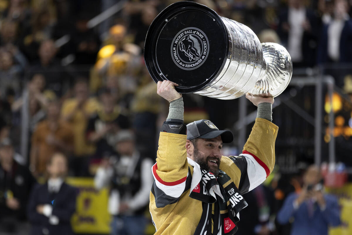 Golden Knights defenseman Alec Martinez (23) celebrates with the Stanley Cup after winning the ...
