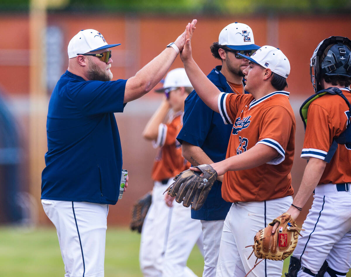 Legacy pitcher Jose Becerra (23) gets a high-five from a coach against Sierra Vista during the ...