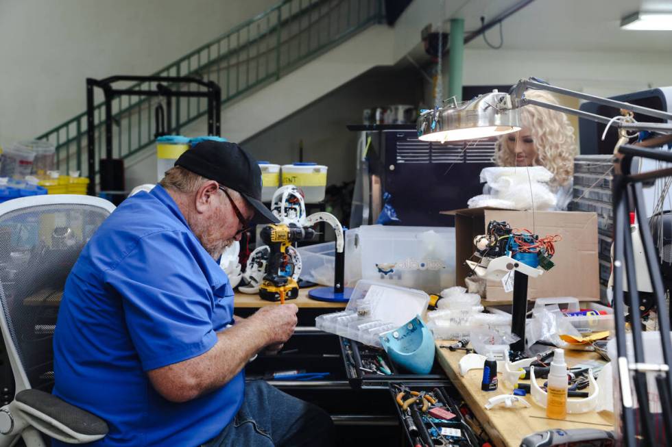Tim Johns, head assembler, works on adding the “mohawk” section of a head to a ro ...