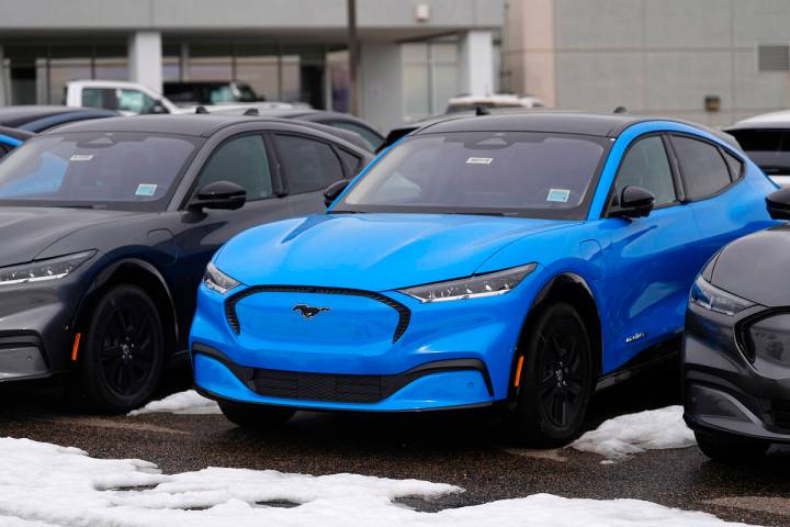 Mustang Mach-E electric 2024 vehicles are displayed at a Ford dealership Sunday, Jan. 21, 2024, ...