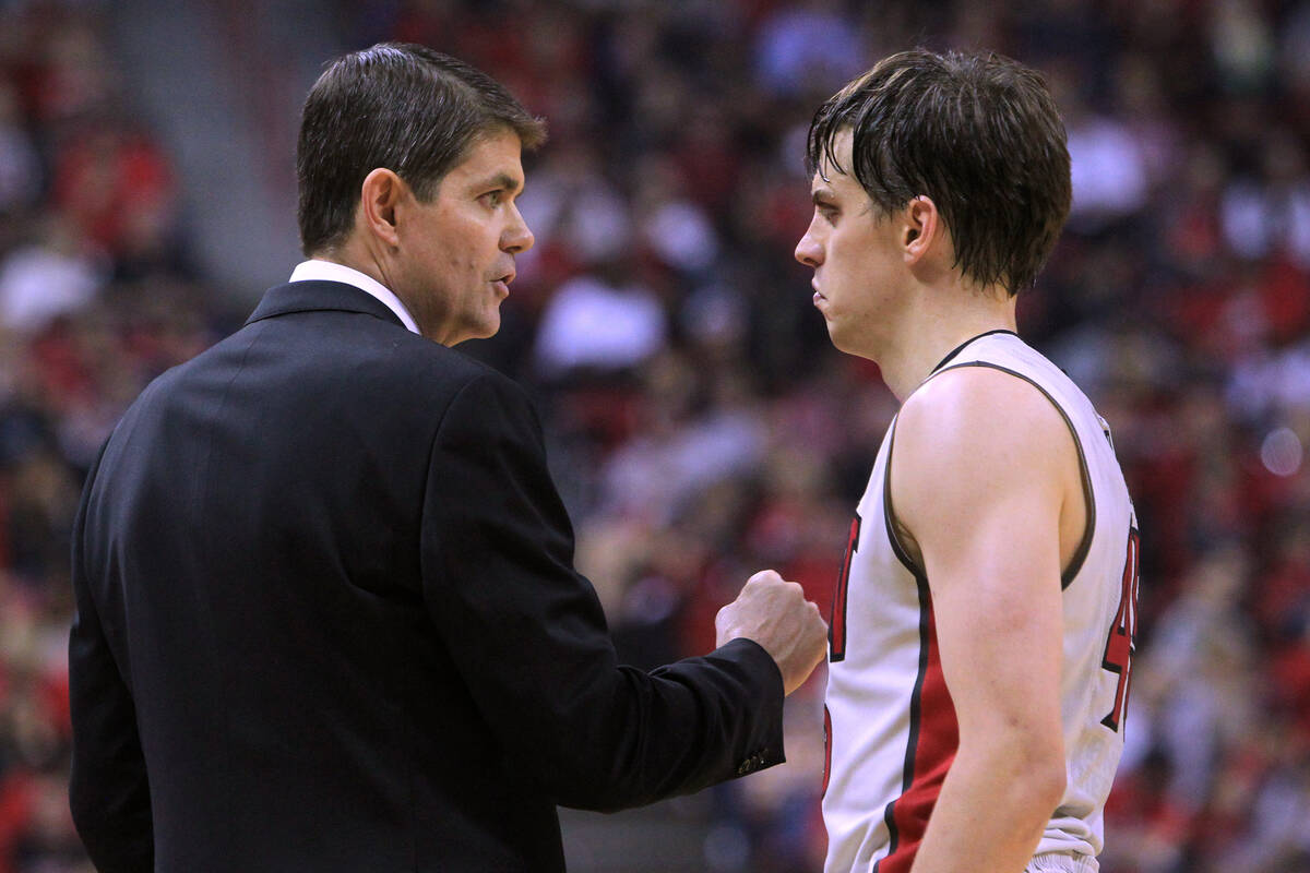 Head coach Dave Rice talks with UNLV guard Cody Doolin during the Rebels home opener against Mo ...
