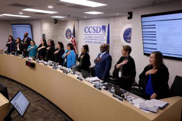 Clark County School Board members recite the Pledge of Allegiance during a meeting at the Edwar ...
