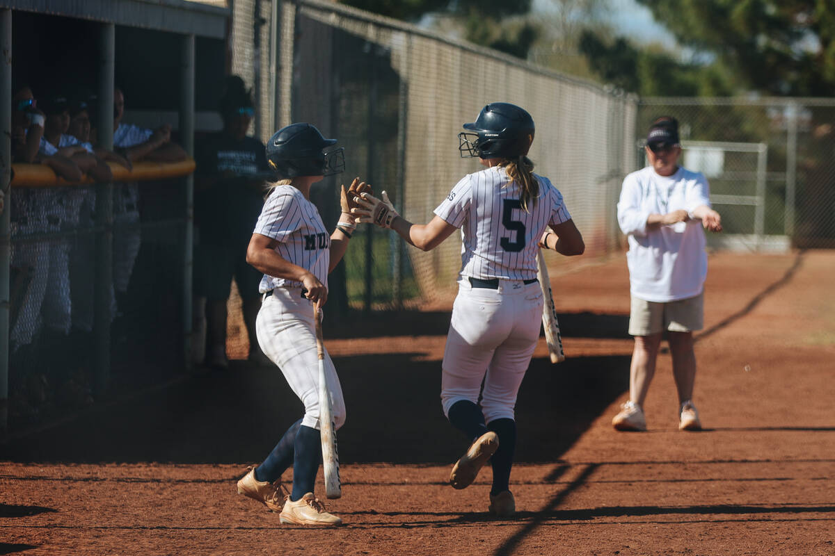 Shadow Ridge’s Kayla Andersen (5) high-fives a teammate during a softball game between S ...