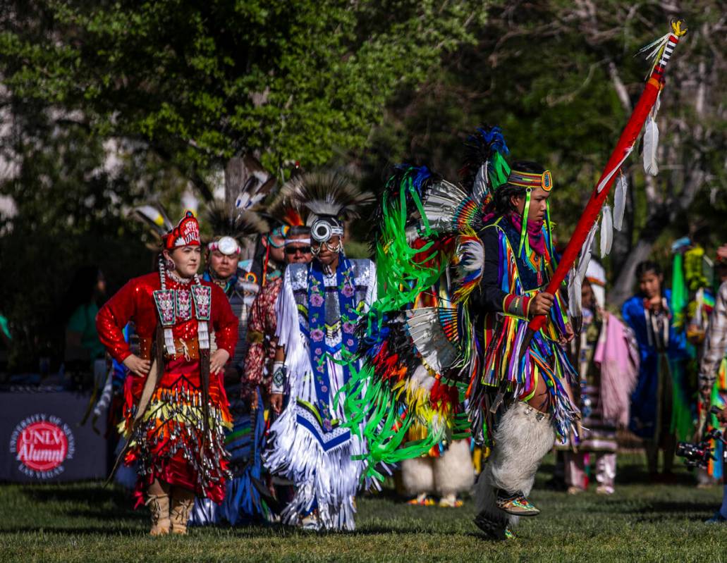 Dancer Tyrell Phillips, 14, with the Dine tribe from Phoenix, carries his family's eagle staff ...