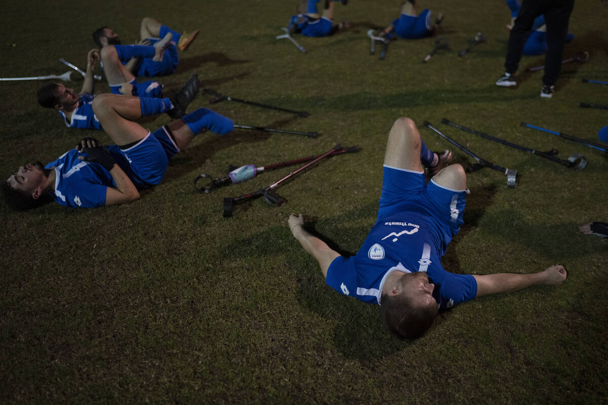 The soccer player of Israel Amputee Football Team, Ben Binyamin, right, stretches after a pract ...