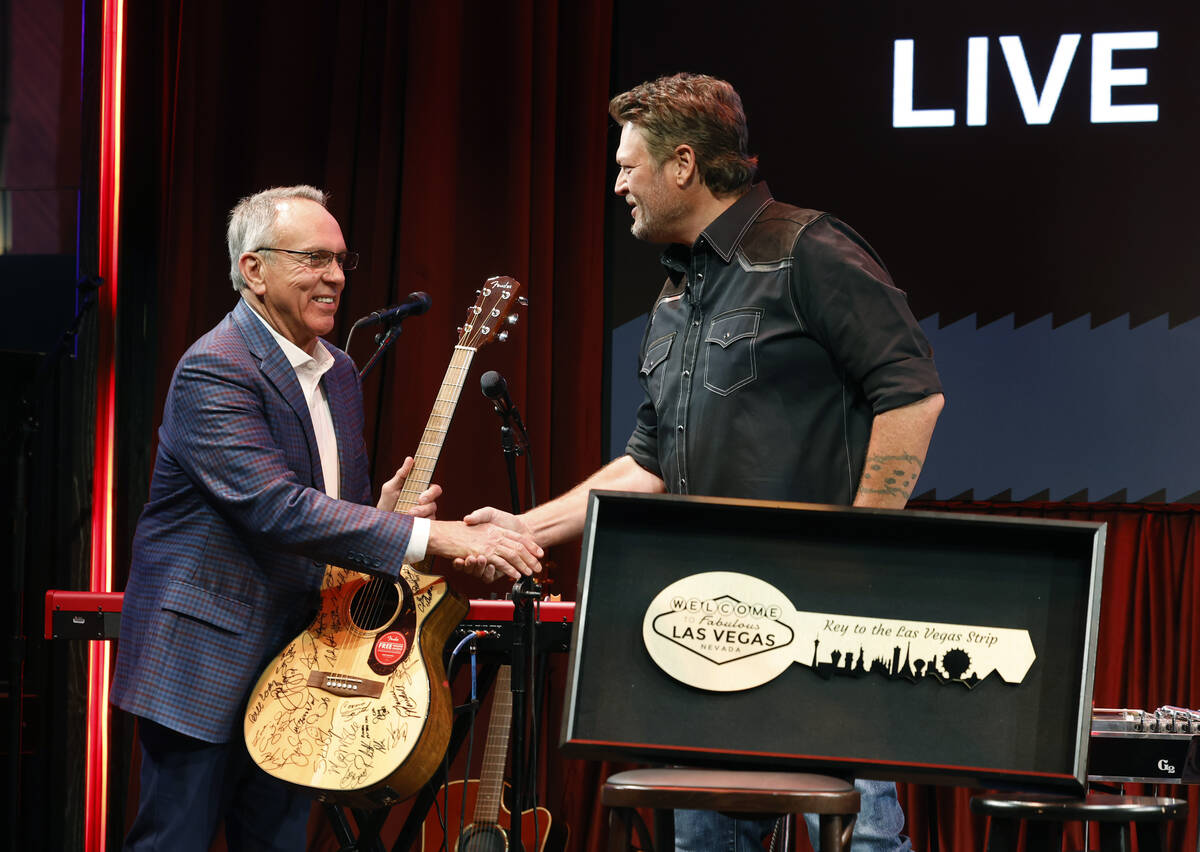 Commissioner James Gibson, left, shakes hands with country singer and songwriter Blake Shelton, ...