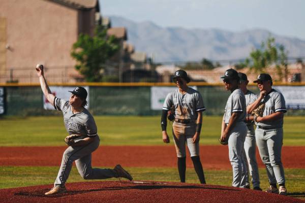 Faith Lutheran pitcher Adrian Dijkman (5) practices pitching from the mound as his teammates lo ...