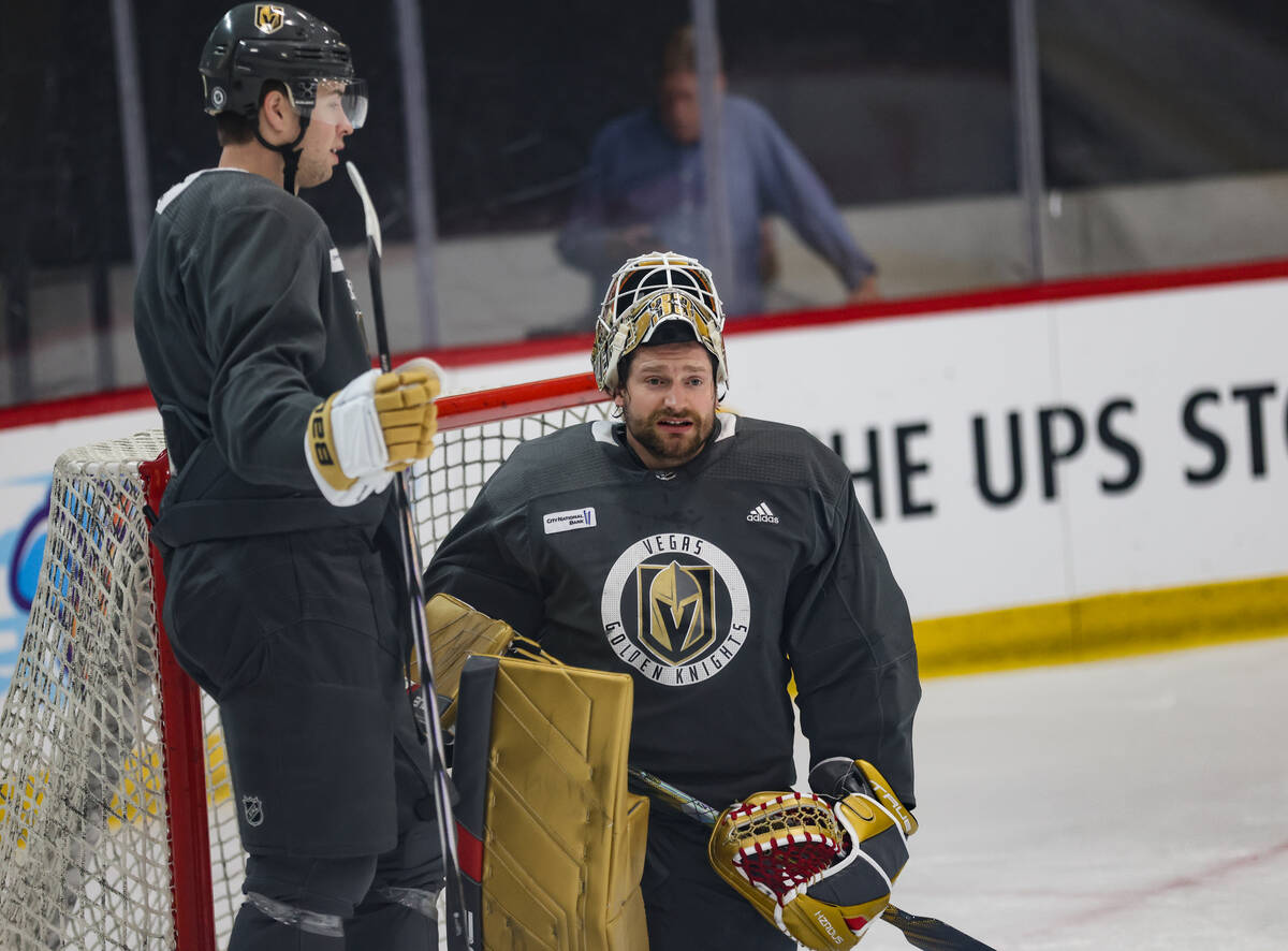 Golden Knights goalie Adin Hill speaks with a teammate during practice at National City Arena i ...