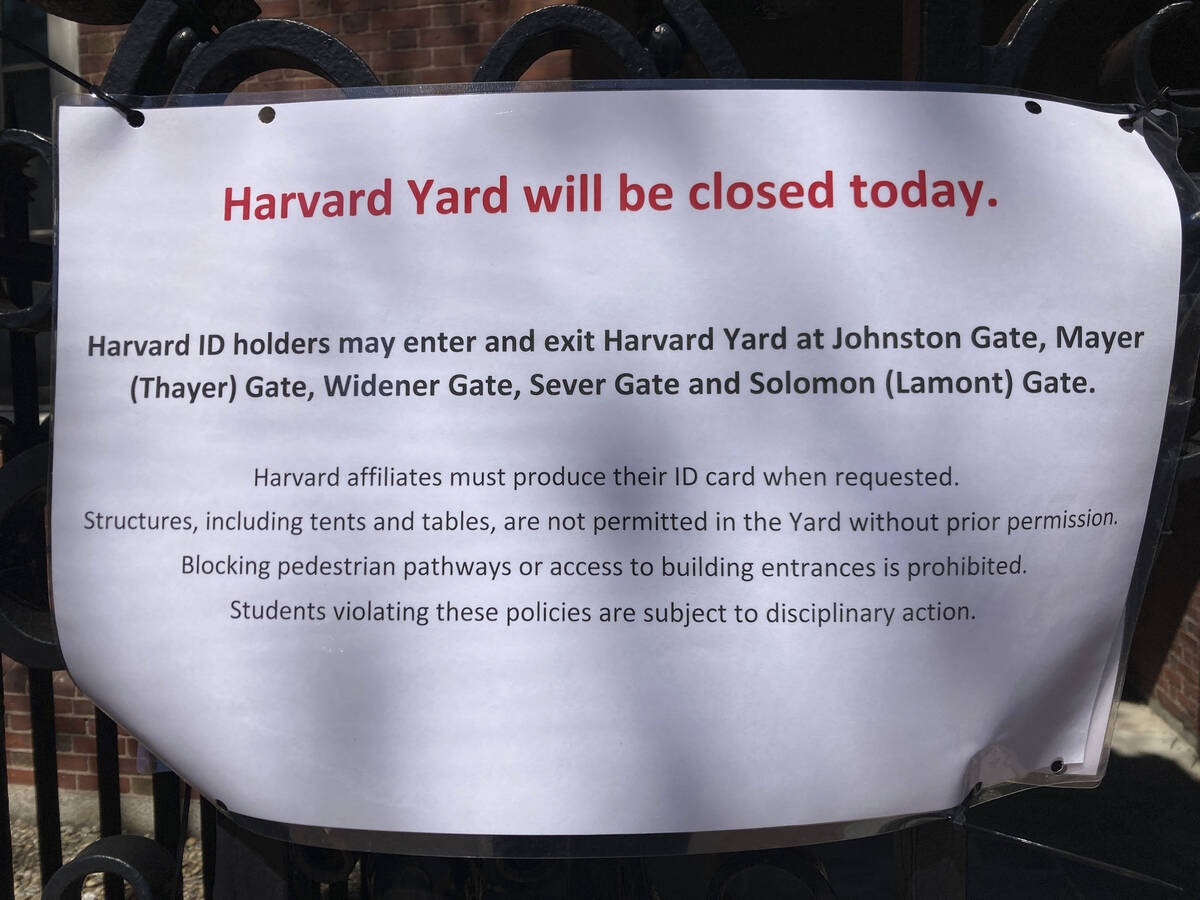 A sign outside Harvard Yard warns that only those with Harvard IDs can enter the yard, outside ...
