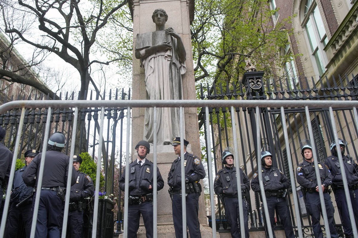 FILE - New York City police in riot gear stand guard outside the Columbia University campus aft ...