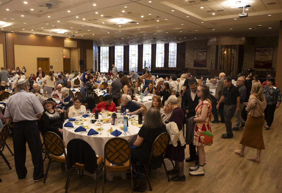 People arrive for a Passover Seder meal at Congregation Ner Tamid on Monday, April 22, 2024, in ...