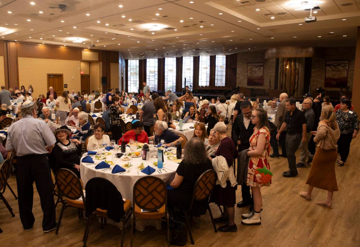 People arrive for a Passover Seder meal at Congregation Ner Tamid on Monday, April 22, 2024, in ...
