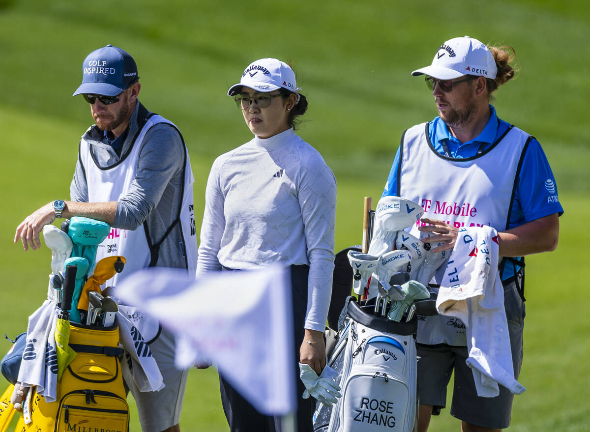 Rose Zhang, center, stands with caddie Brett Olly, right, and another on hole #7 during the sec ...