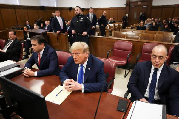 Former president Donald Trump, center, awaits the start of proceedings at Manhattan criminal co ...