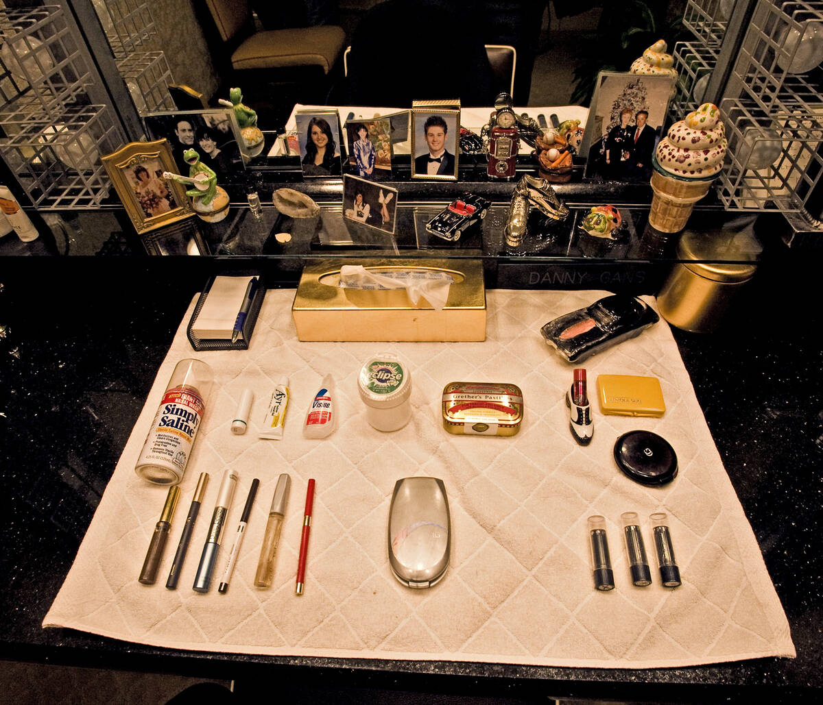 Makeup and family mementos lay on the counter in Danny Gans dressing room at the Encore on Frid ...