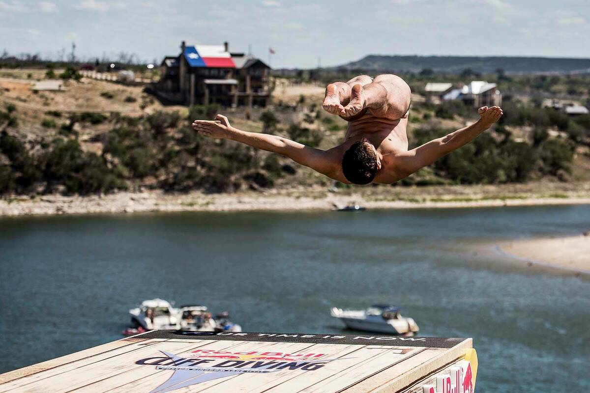 Kyle Mitrione is shown during a diving exhibition with the Red Bull Cliff Diving team in this u ...