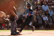 Basic outfielder Troy Southisene (2) celebrates as he scores at home plate during a high school ...