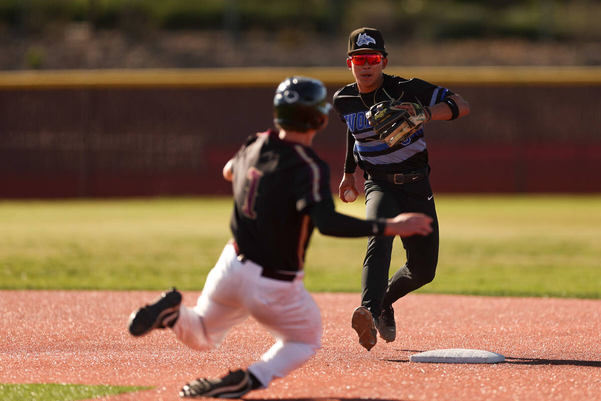 Basic shortstop Ty Southisene (3) runs to out Faith Lutheran outfielder Benjamin Lovering (1) d ...