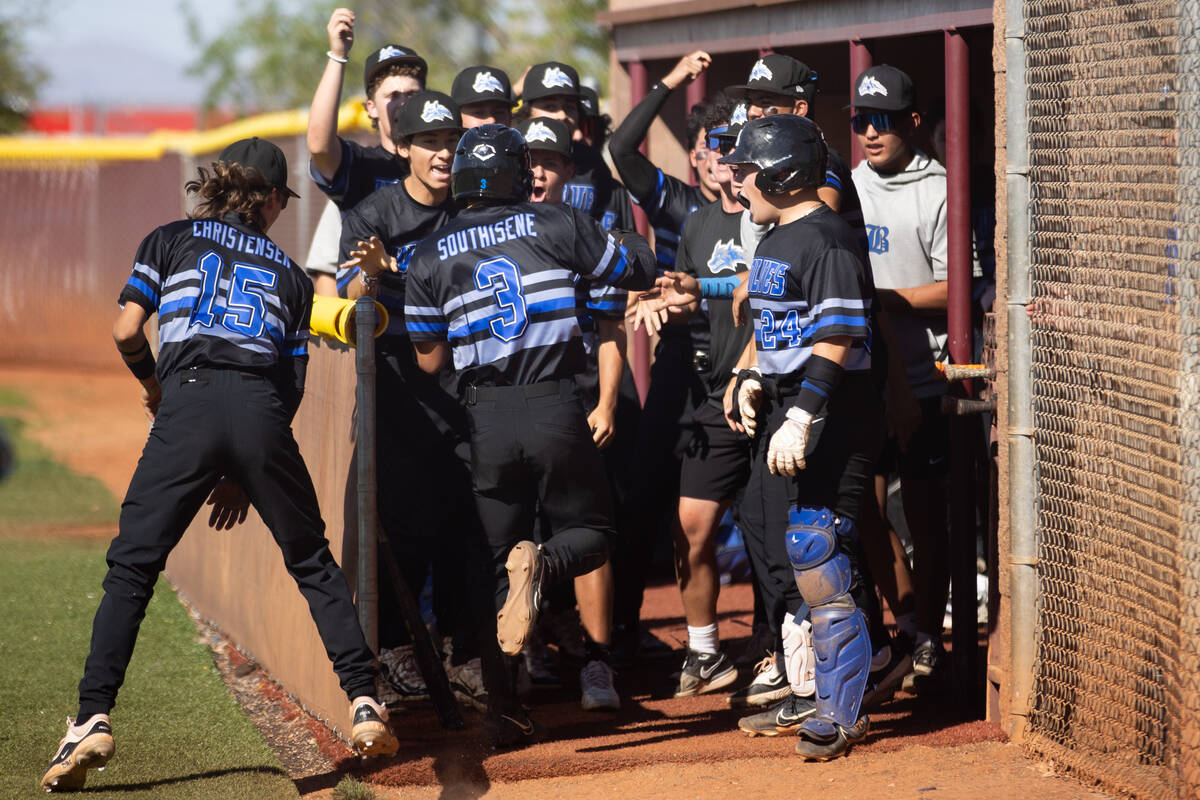 Basic welcomes outfielder Troy Southisene (2) into the dugout after he scored during a high sch ...